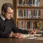 An Oratorian spends time in the library.