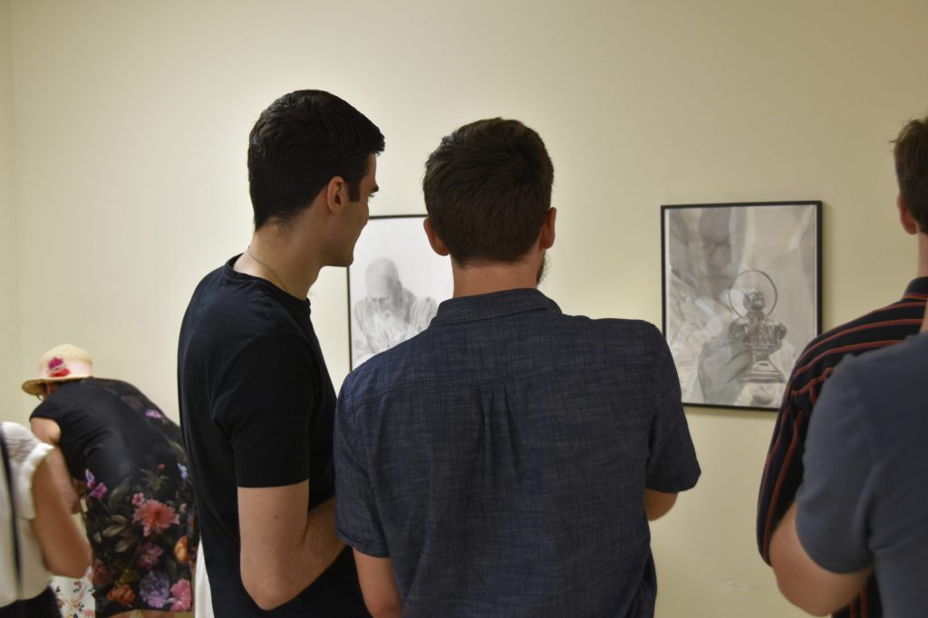 Parishioners discuss Fr Christopher's drawings