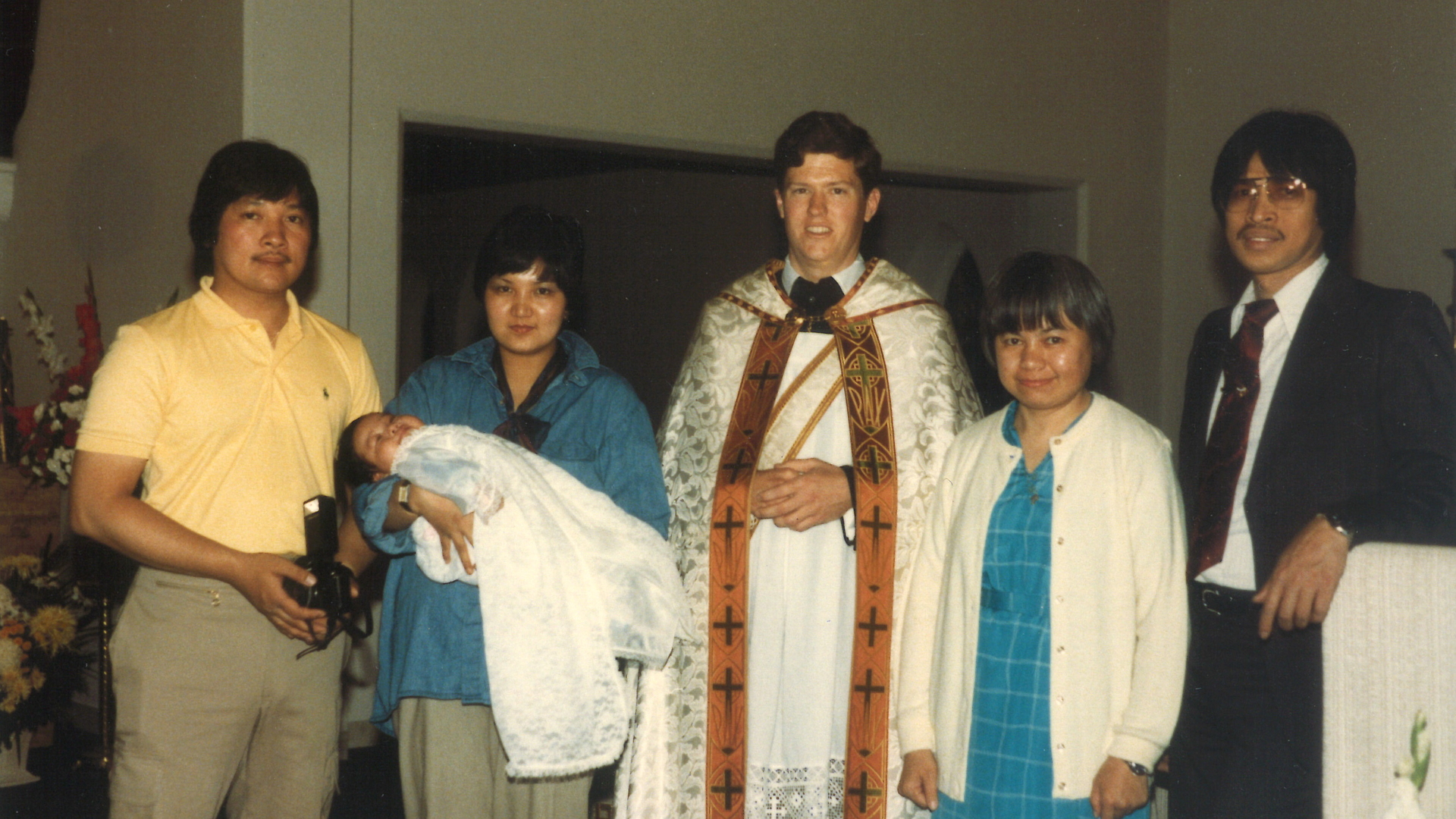 Fr Daniel performs a baptism shortly after his ordination