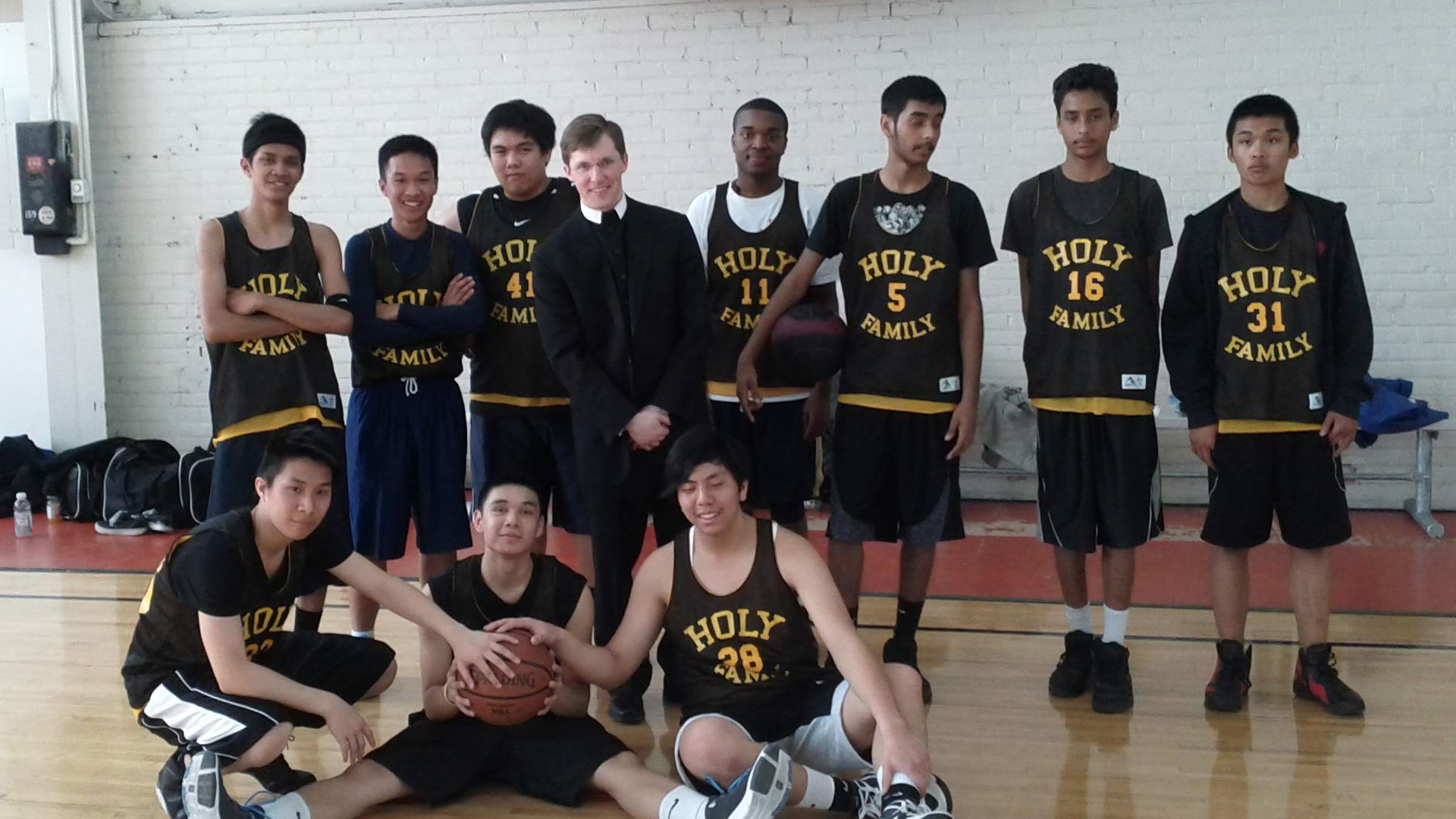 Fr Michael with the parish basketball team