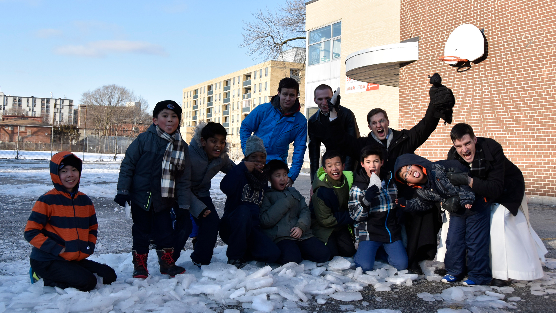 Fr Michael with altar boys after playing basketball in the snow