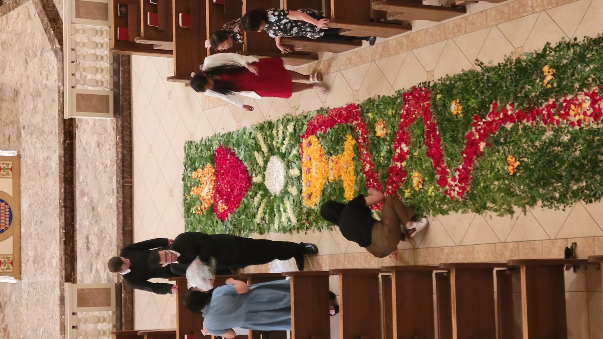 Fr Christopher with volunteers preparing the flower carpet for Corpus Christi
