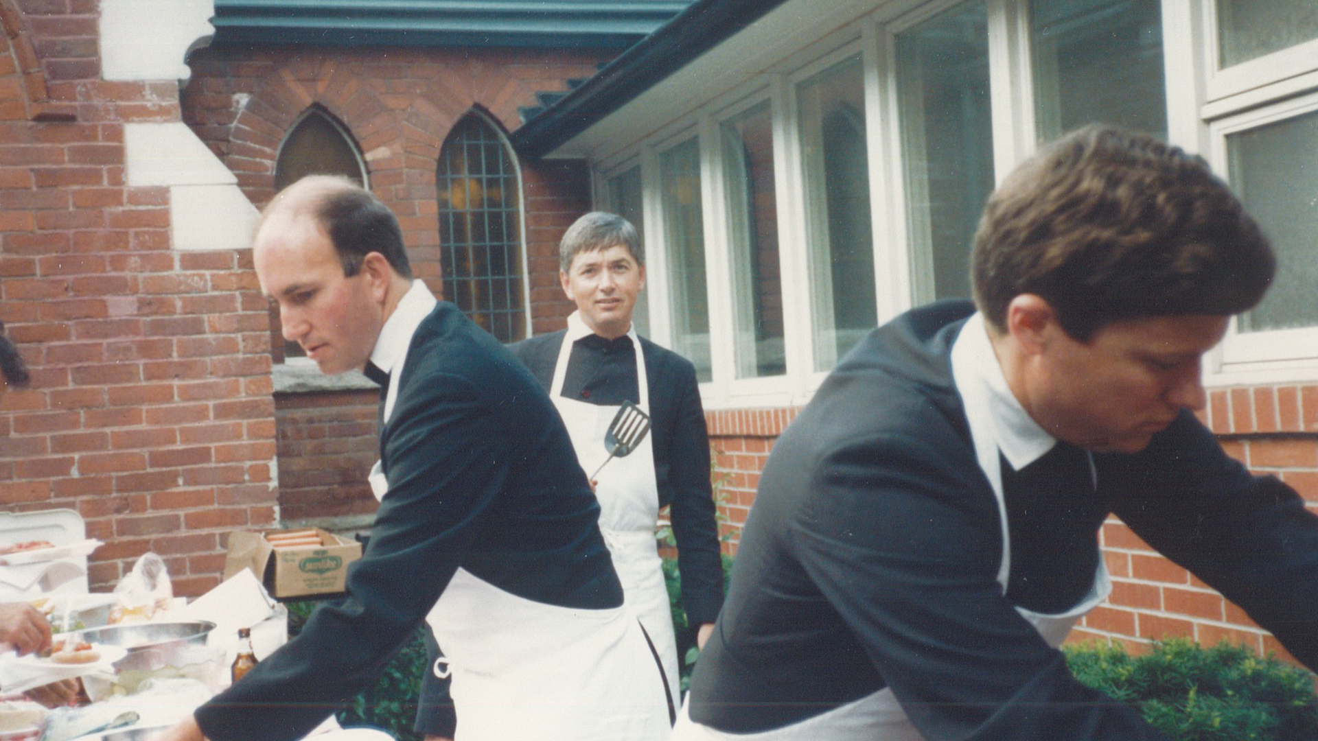 Fr Juvenal, Fr David, and Fr Daniel at a parish barbecue