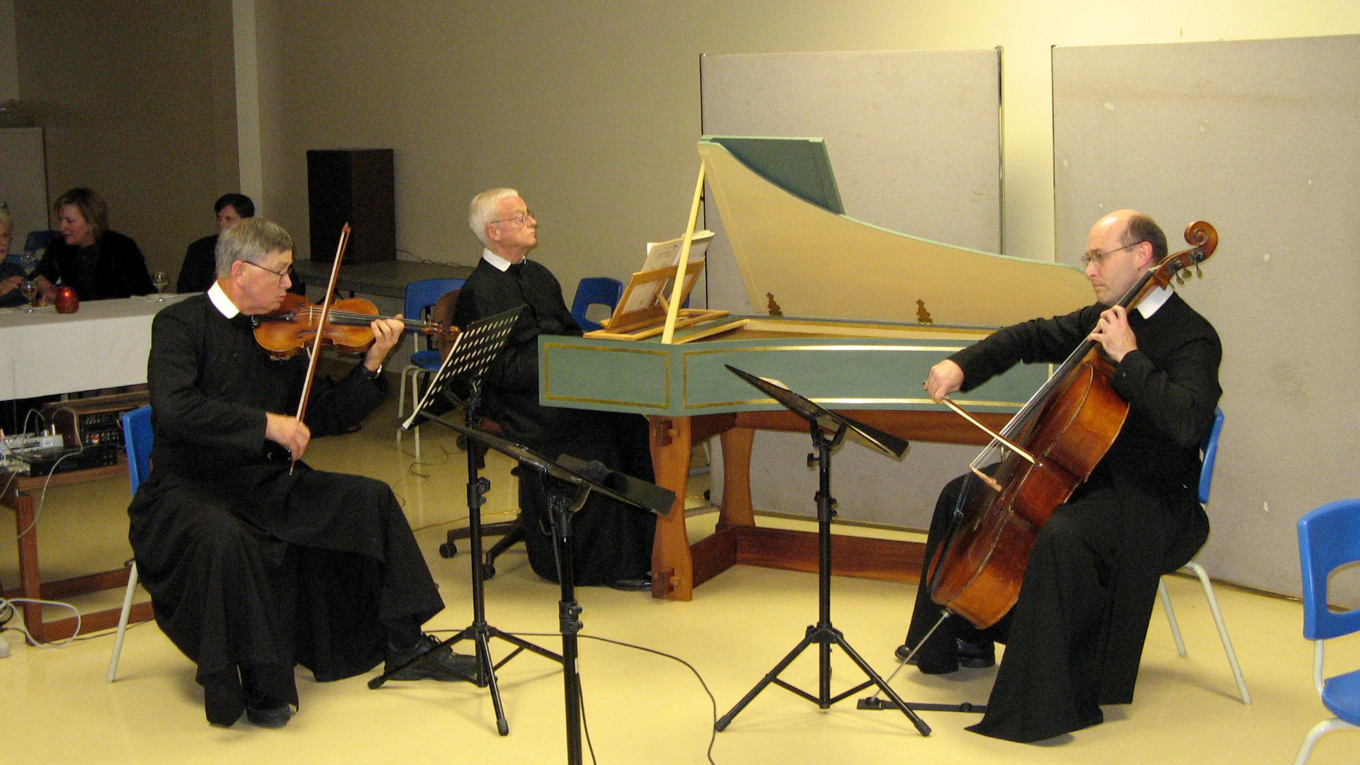 Fr David, Fr Robinson, and Fr Paul perform music